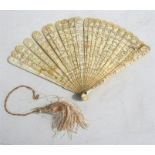 A 19th century Chinese Canton Export brise fan, the guards carved with figures, 19cms (7.5ins) high.