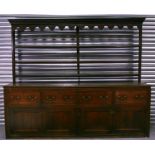 An large 18th / 19th century large oak dresser with associated plate rack, with wrought iron cup