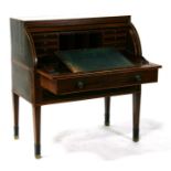 An early 19th century mahogany cylinder bureau with fitted interior above a single long drawer, on