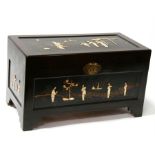 A shibayama style camphor wood trunk decorated with figures, stand 88cms (34.75ins) wide.
