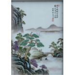 A Chinese porcelain plaque decorated with figures in a landscape and calligraphy, framed, 24 by35cms