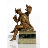 A gilded spelter figure of a huntsman holding a bird, mounted on a green marble base, 17cms (6.