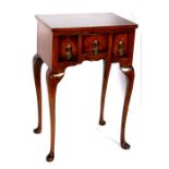 A figured walnut side table with three short drawers, on cabriole legs, 46cms (18ins) wide.