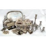 A set of silver napkin rings, a silver plated double vegetable tureen; a four-armed candelabrum; a