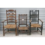 A 19th century rush seated ladder back elbow chair; together with a Lancashire low elbow chair and a