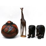 A pair of carved hardwood Ivory Coast African elephants, 26cms (10.25ins) high; a large lidded gourd