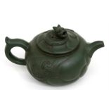 A Chinese Yixing green pottery teapot with dragon finial, 9cms (3.5ins) high.