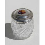 A sterling silver topped cut glass dressing table jar, decorated with an enamel crest.