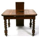 An oak extending dining table on barleytwist legs, 148cms (58.25ins) extended.