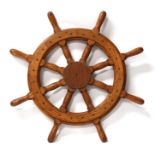 A turned oak ship's wheel with eight spindles, 81cms (32ins) diameter.