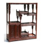 A Chinese hardwood table top display stand with open shelves and two door cupboard, 42cms (16.