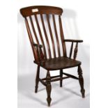 A Victorian Windsor armchair with slatted back, on turned legs.