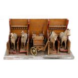 A late 19th / early 20th century model of a stable with four horses and a carriage, 65cms (25.