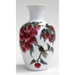 A Chinese vase decorated with lychee fruit and cicada, with calligraphy to verso and red four-