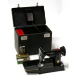 A Singer Featherweight portable sewing machine, model '221K' (CAK7-11), with accessories, in