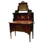An Art Nouveau walnut washstand, the tiled mirrored back above a rouge marble top with cupboard