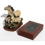 A Chinese soapstone group depicting a horse and foal, mounted on a hardwood stand, 14cms (5.5ins)