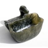 A Chinese figured green soapstone brush washer in the form of a duck with a lily pad, 6cms (2.25ins)