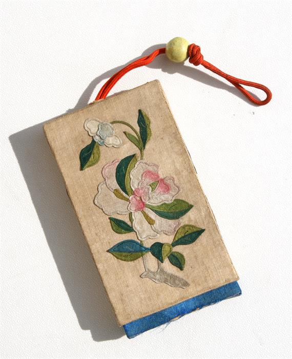 A 19th century Chinese silk embroidered box purse decorated with flowers, 7 by 11.5cms (2.25 by 4.