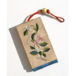 A 19th century Chinese silk embroidered box purse decorated with flowers, 7 by 11.5cms (2.25 by 4.