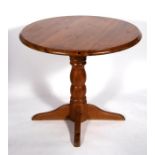 A modern pine table on turned column and four legs, 90cms (35.5ins) diameter.