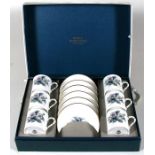 A cased set of Royal Worcester coffee cans and saucers, decorated with flowers.