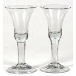 A pair of hand blown wine glasses, 18cm (7ins) high.