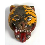 A South American painted wooden ceremonial tiger mask, 33cm (13ins) high.
