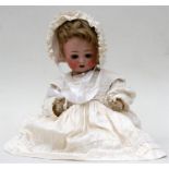 A German Bisque headed doll "8 1/2" with blue eyes, open mouth and composite body and bent limbs,