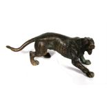 In the manner Franz Bergman, a bronze figure of prowling lion, 14.5cm (5.25ins) long.