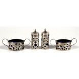 A four-piece pierced silver cruet set with blue glass liners, Birmingham 1914,