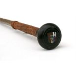 A Makila Basque wolf stick, having a woven leather grip with horn and enamel handle, 'Etsaien