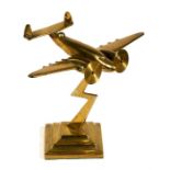 A trench art style brass model of an airplane on a lightening bolt stand, 21cm (8.25ins) high.