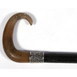 A Victorian ebonised walking stick with rhino horn handle and silver collar, 82cm (32.25ins) long