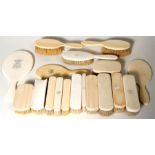 A large quantity of late 19th century and Edwardian ivory backed brushes and hand mirrors.