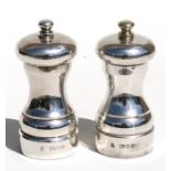 A matched pair of silver salt & pepper mills, London 1985 and 1991, makers mark for 'M C Hersey &
