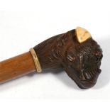 A mahogany walking stick, with carved bull dog head handle, 90cm (35.5ins) long Condition Report