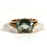 A 9ct gold ring set with a large central aquamarine and four small diamonds, approx UK size N.