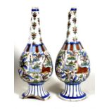 A pair of Persian / Islamic vases decorated with deer, birds and flowers, 38cm (15ins) high (a/f).