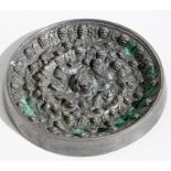 A Chinese tang style silvered bronze mirror decorated in relief with mythical creatures and fruit,