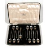 A cased set of twelve silver teaspoons and sugar tongs, Sheffield 1935.