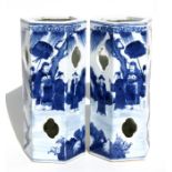 A pair of Chinese hexagonal form blue & white wig stands decorated with figures in a landscape, with