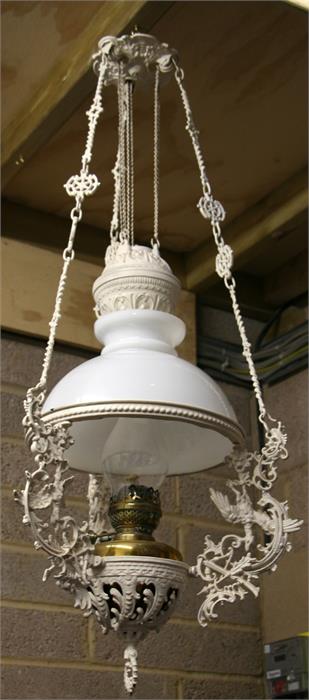 A hanging oil lamp with weighted rise and fall counterbalance, the ornate frame cast with birds,