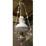 A hanging oil lamp with weighted rise and fall counterbalance, the ornate frame cast with birds,
