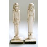 A pair of Egyptian carved bone figures standing on horn plinths, 14cm (5.5ins) high