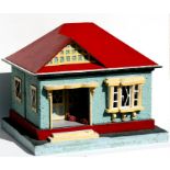 An early to mid 20th century doll's house and and accessories, 59cms (23.25ins) wide.