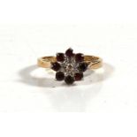 An 18ct gold diamond garnet cluster ring, approx UK size J.