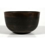 A Tibetan bronze singing bowl, 15cm (6ins) wide. Condition Report Crack to rim otherwise good