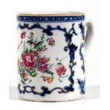 A Chinese porcelain mug decorated in underglaze blue with foliate panels, 11.5cm (4.5ins) high.
