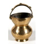 A Turkish / Islamic brass spittoon with calligraphy to the upper rim, 23cm (9ins) high.